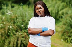 African volunteer woman in park. Africa volunteering, charity, people and ecology concept. photo