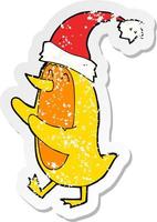 retro distressed sticker of a cartoon bird wearing xmas hat vector