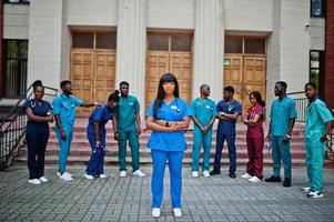 Group of african medical students posed outdoor against university door. photo