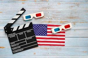 Flat lay of clapperboard and 3d glasses with USA flag on wooden background with copy space, Happy Independence Day photo