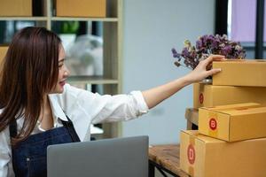 Online sales woman business owner Receive orders and deliver products with boxes to customers. Online SME business concept photo