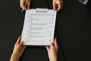 Candidate holding resume documents sent to recruiter for a new job. photo