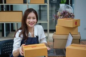 Online sales woman business owner Receive orders and deliver products with boxes to customers. Online SME business concept photo