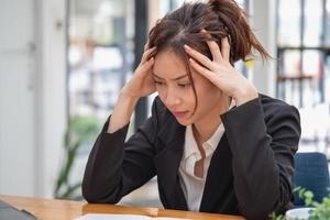 Burnout syndrome at work concept. exhausted overworked woman working in office.Concept Burnout Syndrome. photo