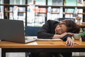 Burnout syndrome at work concept. exhausted overworked woman working in office.Concept Burnout Syndrome. photo