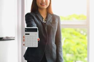 Business woman using office annual balance display calculator.accounting concept. photo