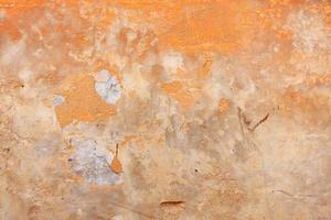 Abstract pattern on an old wall with the texture of old peeling plaster. photo