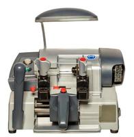 Industrial machine for making copies of keys for door locks. The image is isolated on a white background. Closeup. photo