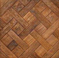 Rectangular wooden slats are perfectly matched to each other and neatly laid out in a diamond pattern. photo