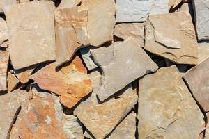 The texture of the stone background of shale sandstone in bright sunlight. photo