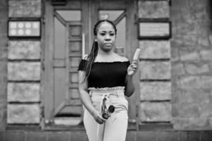 Stylish african american woman at sunglasses with ice cream. photo