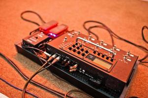 Effects unit with pedals and compressors for guitar legs. photo