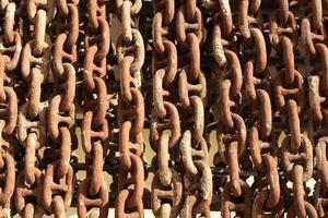 Old rusty ship anchor chain links close up. photo