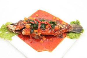 Fried snapper with chili sauce on the plate photo