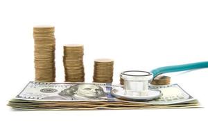 Stack of coins and money and stethoscope photo