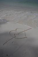 hearts drawn on the sand of a beach photo