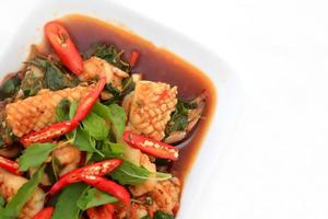 Spicy seafood fried served on white dish photo