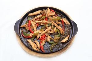 Hot skillet of chicken fajitas and vegetables photo