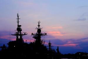 battleship with sunset behind photo