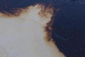 Gulf oil spill is shown on a beach photo