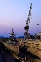 Crane near a covered dry dock at the shipyard photo