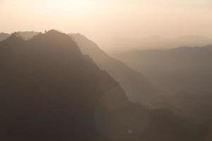 Foggy and volcano mountain during sunrise taken from Pinajagun II view point ,Indonesia photo