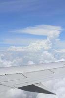 wing of the airplane under the clouds photo