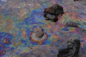 crude oil in sea water and rainbow reflection photo