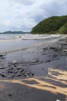 Gulf oil spill is shown on a beach photo