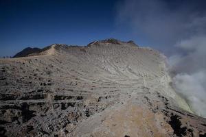 Sulfur mine with workers in Kawah Ijen, Java, Indonesia photo