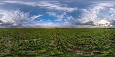 full seamless spherical hdri panorama 360 degrees angle view on among fields in spring evening with awesome clouds in equirectangular projection, ready for VR AR virtual reality content photo