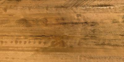 view from above on texture of gravel road with car tire tracks photo