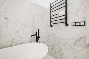 toilet and detail of a corner shower cabin with wall mount shower attachment photo