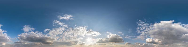 Seamless hdri panorama 360 degrees angle view blue sky with beautiful fluffy cumulus clouds with zenith for use in 3d graphics or game development as sky dome or edit drone shot photo