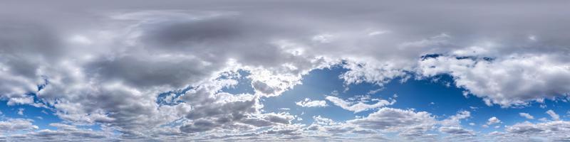 Seamless hdri panorama 360 degrees angle view blue sky with beautiful fluffy cumulus clouds with zenith for use in 3d graphics or game development as sky dome or edit drone shot photo