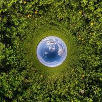 Inversion of little planet transformation of spherical panorama 360 degrees. Spherical abstract aerial view in field with awesome beautiful clouds. Curvature of space. photo