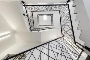 white stairs  emergency and evacuation exit spiral stair in up ladder in a new office building photo