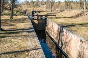 gateway lock sluice drawbridge construction on river, canal for passing vessels at different water levels photo