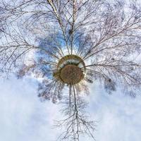 Little planet transformation of spherical panorama 360 degrees. Spherical abstract aerial view in field with awesome beautiful clouds. Curvature of space. photo