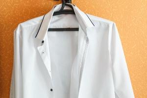 white shirt of the groom on an orange wall photo