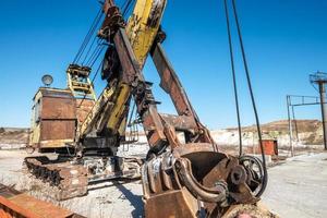 huge old rusty abandoned mining excavator photo