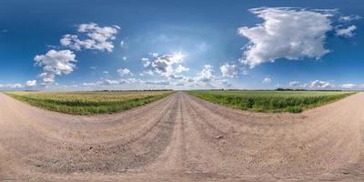 Full spherical seamless hdri panorama 360 degrees angle view on no traffic white sand gravel road among fields with clear sky with beautiful clouds in equirectangular projection, VR AR content photo