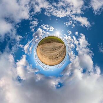 Little planet transformation of spherical panorama 360 degrees. Spherical abstract aerial view in field with awesome beautiful clouds. Curvature of space. photo