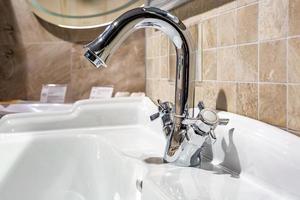 Water tap sink with faucet in expensive loft bathroom photo