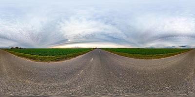 full seamless spherical hdri panorama 360 degrees angle view on asphalt road among fields in autumn day with gray pale clouds in equirectangular projection, ready for VR AR virtual reality content photo