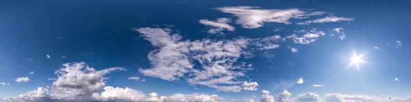 blue sky with beautiful fluffy cumulus clouds. Seamless hdri panorama 360 degrees angle view without ground for use in 3d graphics or game development as sky dome or edit drone shot photo