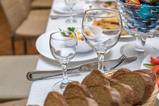 mesa de banquete servida con instrumentos y decorada con copas de vino vacías foto