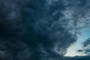 dark Blue sky background with evening fluffy curly rolling altocumulus altostratus clouds photo