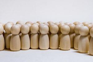 follow the leader or human resource management concept. crowd of wooden people photo