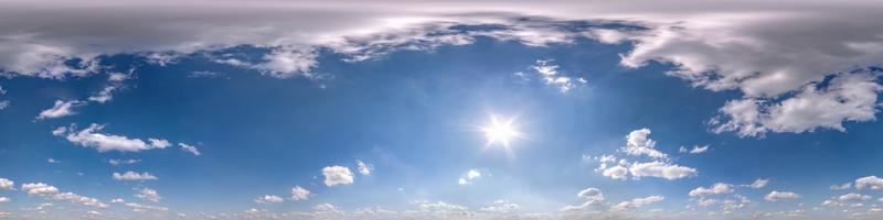 blue sky with beautiful fluffy cumulus clouds. Seamless hdri panorama 360 degrees angle view without ground for use in 3d graphics or game development as sky dome or edit drone shot photo